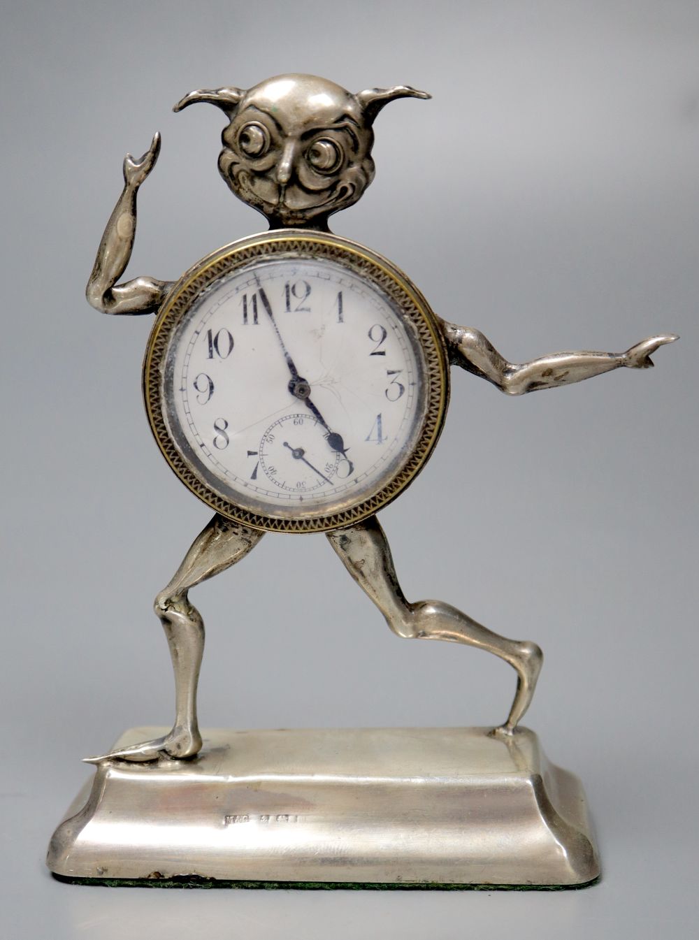 An early 20th century novelty silver mounted timepiece, modelled as the Lincoln Imp(a.f.), height 12.4cm, weighted.